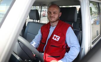Denys, a Fleet Manager for the IFRC working in Ukraine, sits in his vehicle before heading out to assist the response to the escalation of conflict in the country in 2022.