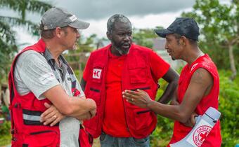 IFRC, Swiss Red Cross and Malagasy Red Cross workers talk about a planned aid distribution in Madagascar in March 2022.