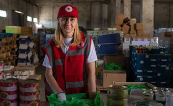 A Ukrainian Red Cross volunteer prepares packages of basic aid items in a service centre in Uzhhorod, Ukraine to be distributed to displaced people arriving in the city.