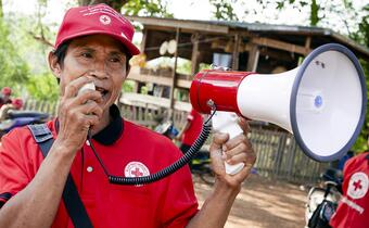 Khammouane Province, Laos, 2015Announcing warnings to the community. A member of the Village Disaster Protection Unit announces evacuation warnings during a Community Based Disaster Risk Reduction sim