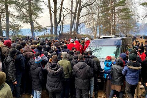 Belarus Red Cross volunteers distribute food, water, hygiene kits, blankets and clothing to groups of people trying to leave the country who set up makeshift camps on the border with Poland in early November 2021.