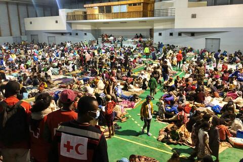 Malagasy Red Cross volunteers provide relief items and services to thousands of people in a temporary accommodation centre set up in January 2022 to help people affected by torrential rains, Tropical Storm Ana and Cyclone Batsirai.