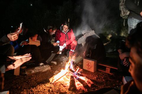 A volunteer from the Red Cross Society of Bosnia and Herzegovina provides warm blankets, first aid and food to refugees and migrants as part of a mobile team in the town of Kljuc in October 2019