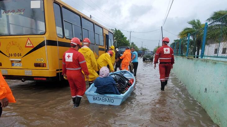 Cuban Red Cross volunteers transport an elderly lady via boat through flood waters caused by Hurricane Ian, which battered the region in late September 2022. Many National Societies in the region responded to help affected communities cope with the damage caused by the category 4 hurricane.