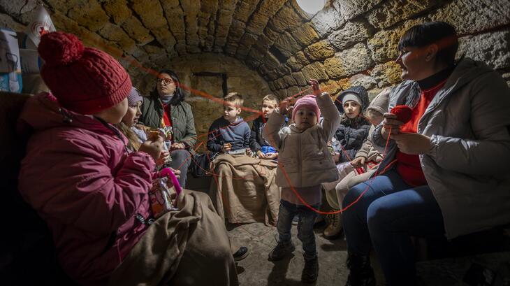 Ukrainian Red Cross volunteer Olena Boiko and her daughter in a shelter with other children, following a siren alarm on the 29th January 2024.  Olena: "... it was very difficult. We had lost our house and had to leave everything behind. But we have to survive, move forward and continue to raise our children"